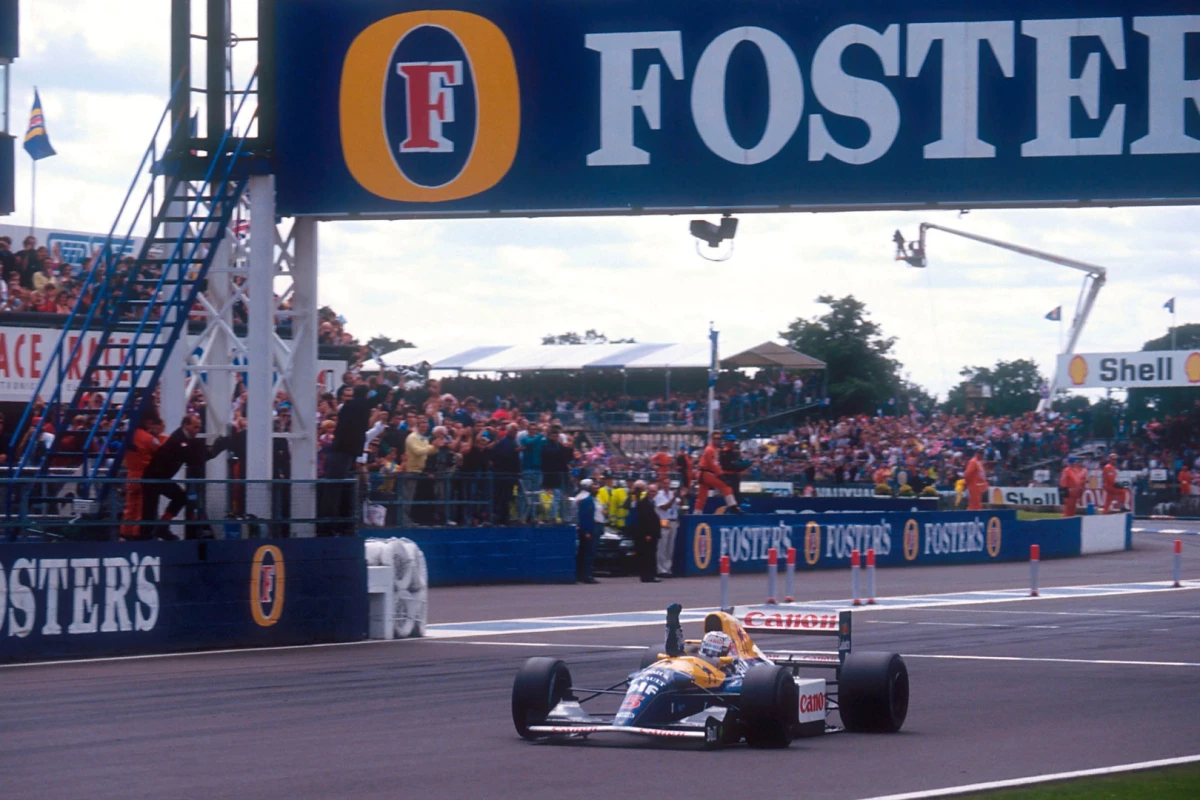 Nigel Mansell takes the win in the 1992 British Grand Prix at Silverstone on 12 July 1992. The car Mansell is driving in this image is not the auction car, but an identical car driven by Ricardo Patrese, which finished second. Mansell took pole position for the race by a whopping 1.9 second margin.