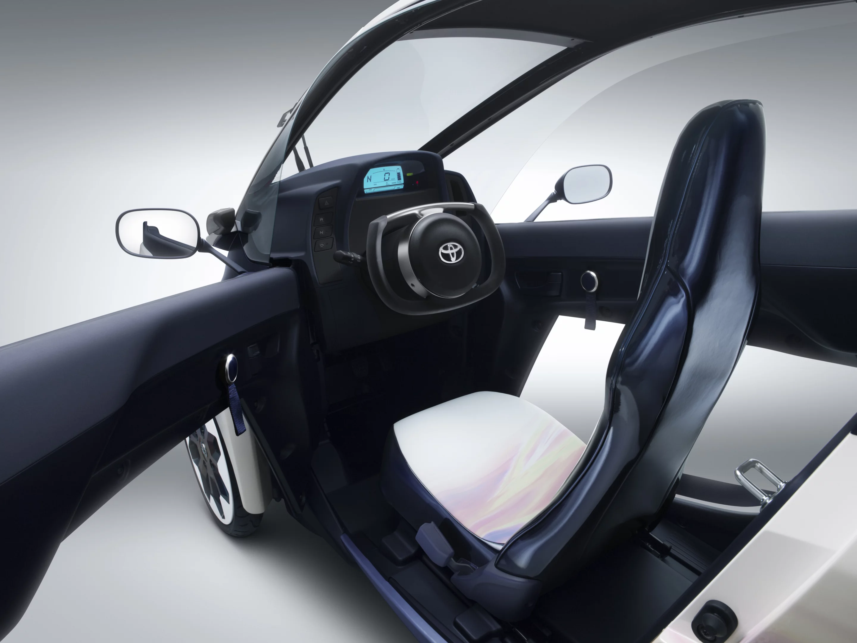 Toyota's i-ROAD is a fully-enclosed, two-seater, three-wheeled, fully-electric, Personal Mobility Vehicle (PMV)