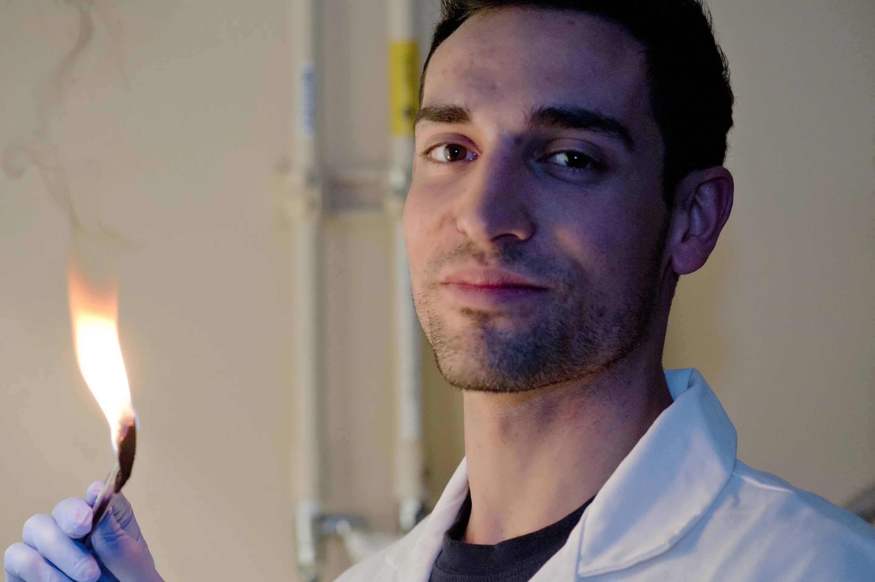 Rice University graduate student Daniel Hashim burns oil out of a sponge-like material so it can be reused (Photo: Jeff Fitlow/Rice University)