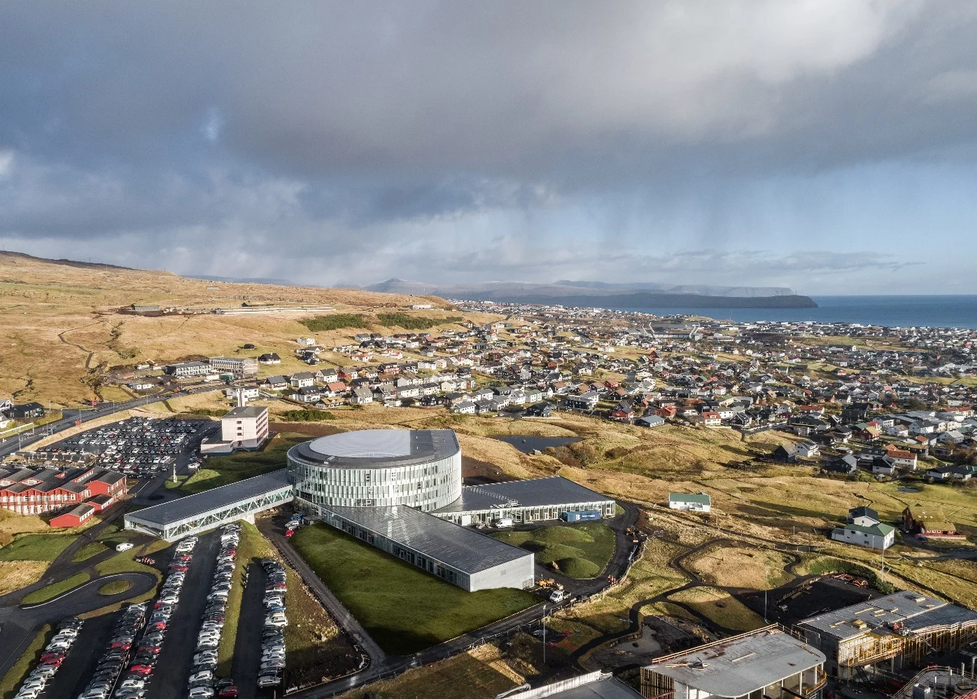 Grass planted on Glasir's roofs will eventually cover it in green and help the building blend in with the landscape more fully