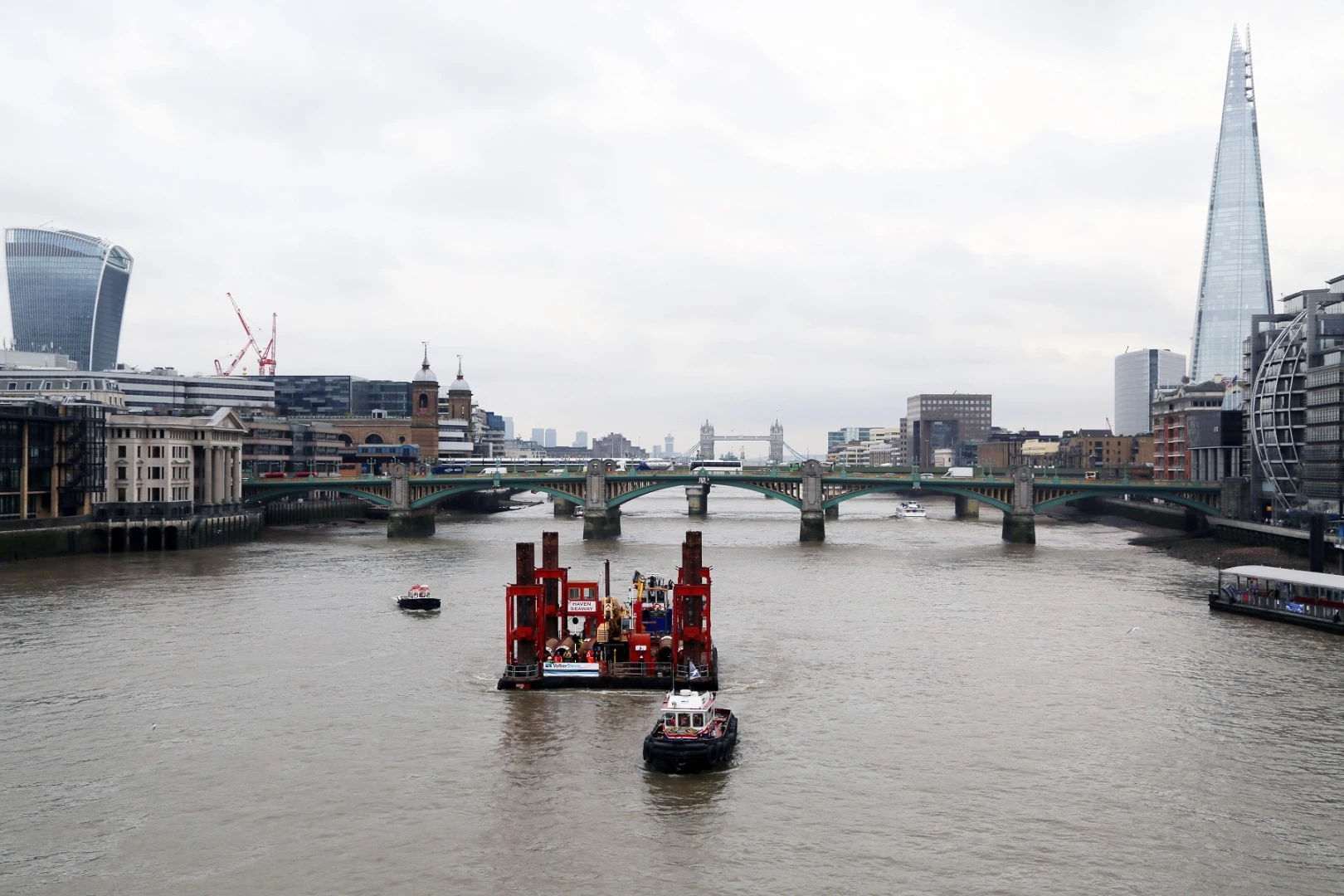 A crane has been moved into place at Blackfriars on the River Thames, signaling the start of work on the Thames Tideway Tunnel