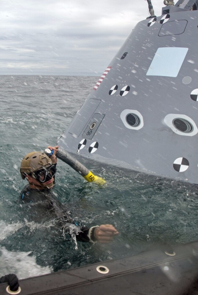 Petty Officer 2nd Class Ryan Mead attaching a tow line