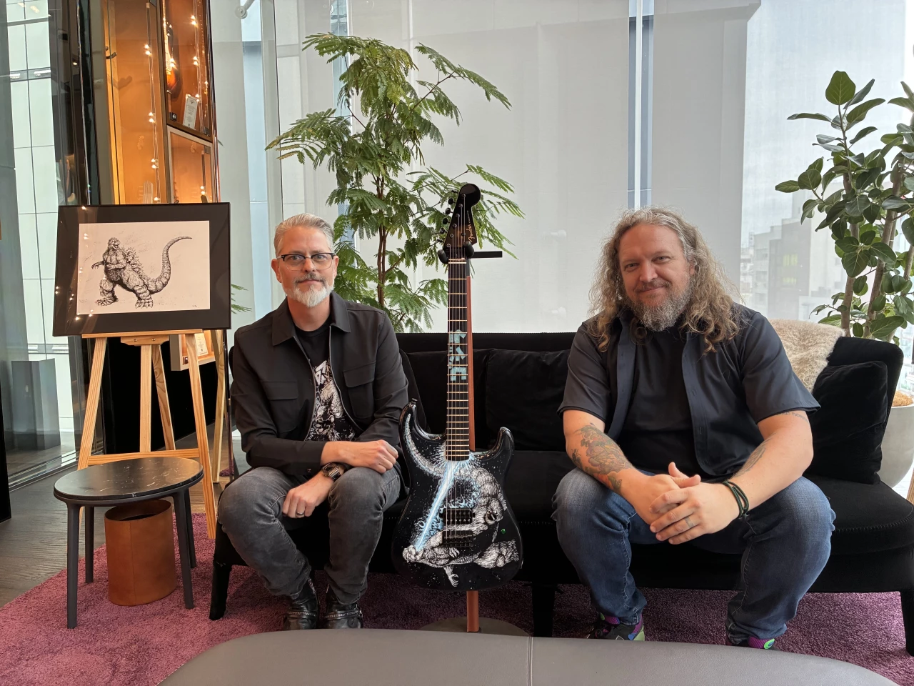 Illustrator Tom Neely (left) and master buidler Andy Hicks with their Godzilla guitar