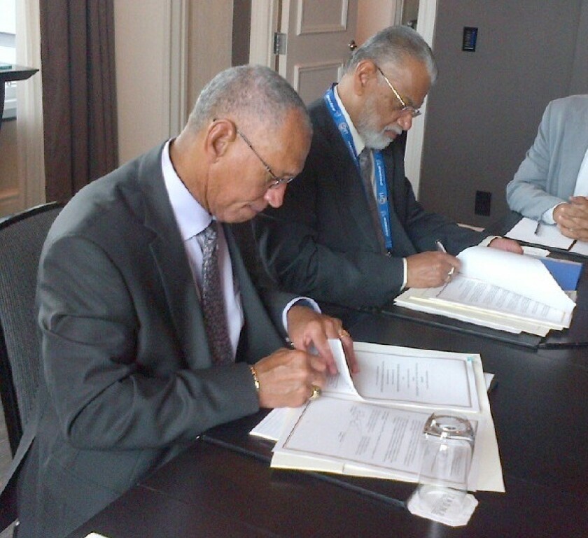 NASA Administrator Charles Bolden (left) and Chairman K. Radhakrishnan of the Indian Space Research Organisation signing documents in Toronto on September 30, 2014 (Image, NASA)