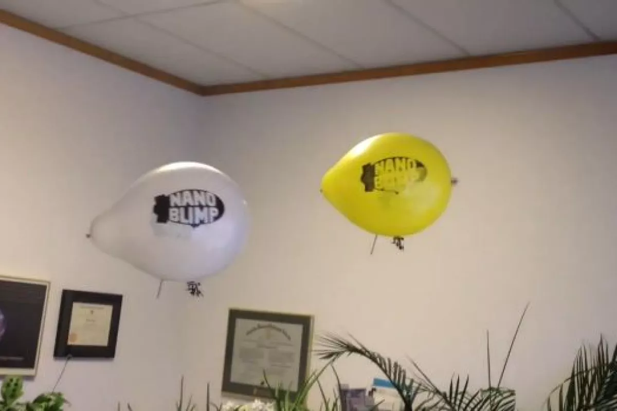 Two Nanoblimps, engaging in aerial warfare in an office