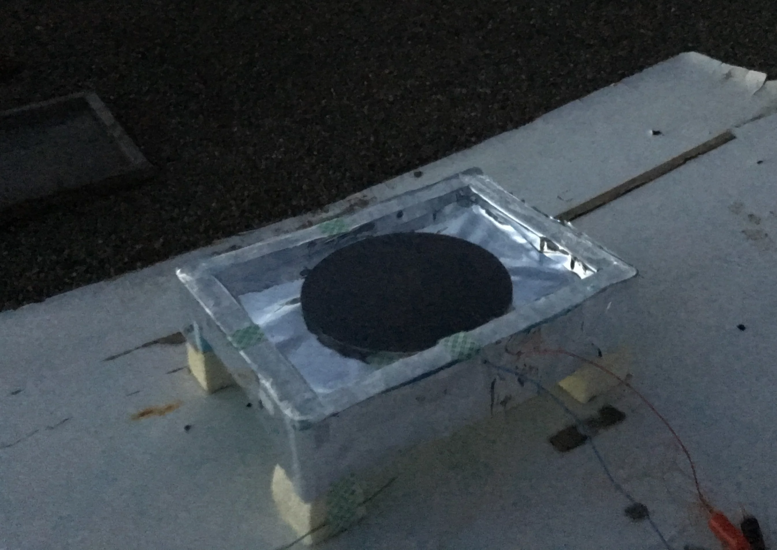 The thermoelectric generator uses a black aluminum disk to radiate heat into the atmosphere, and a polystyrene enclosure to keep the air inside warm.