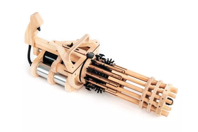 Made from wooden CNC-machined pieces, the Rubber Band Minigun’s 12 barrels can be loaded up with 144 rubber bands