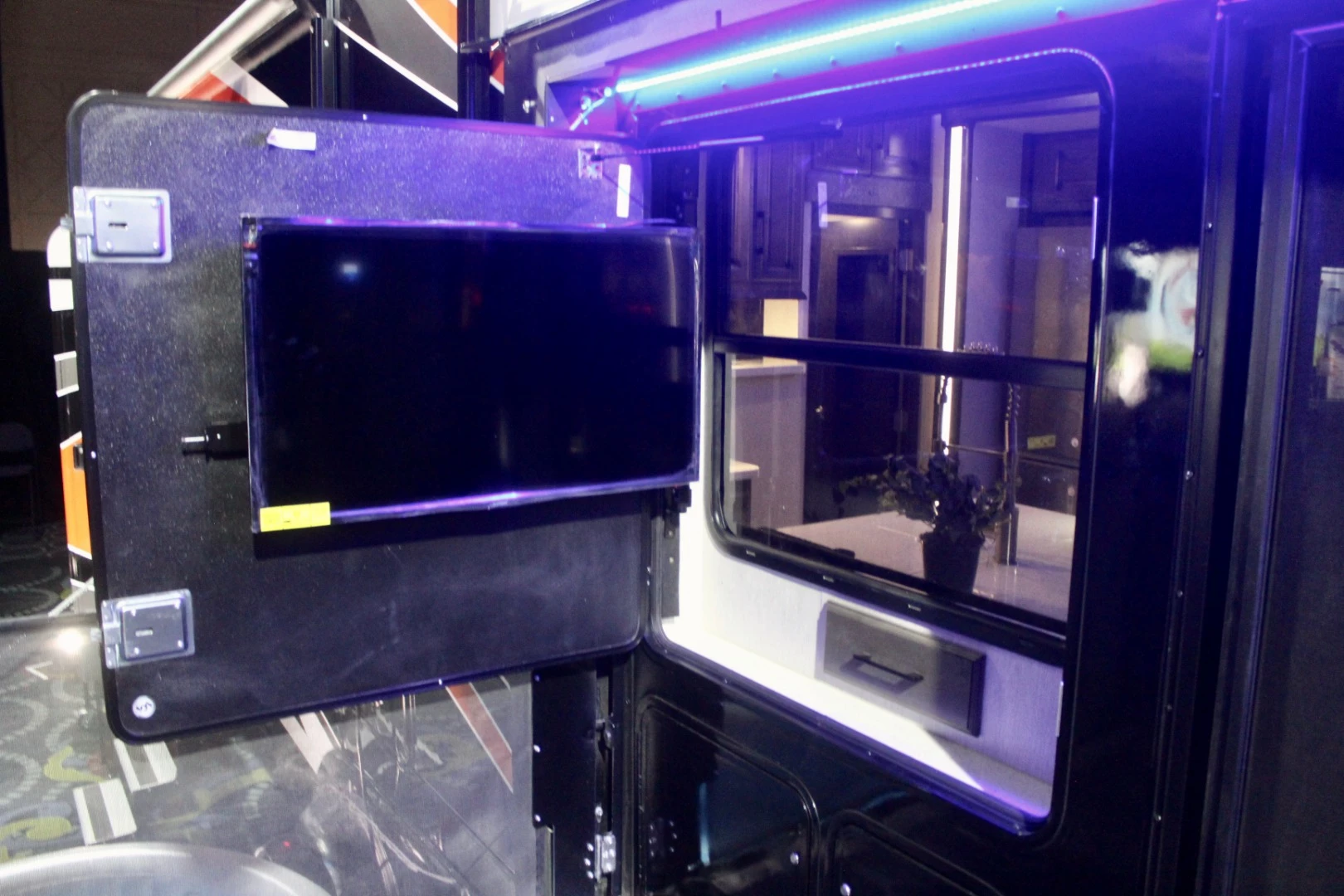 The side deck has a swing-out TV of its own, an option on the Cyclone 4720 production trailer