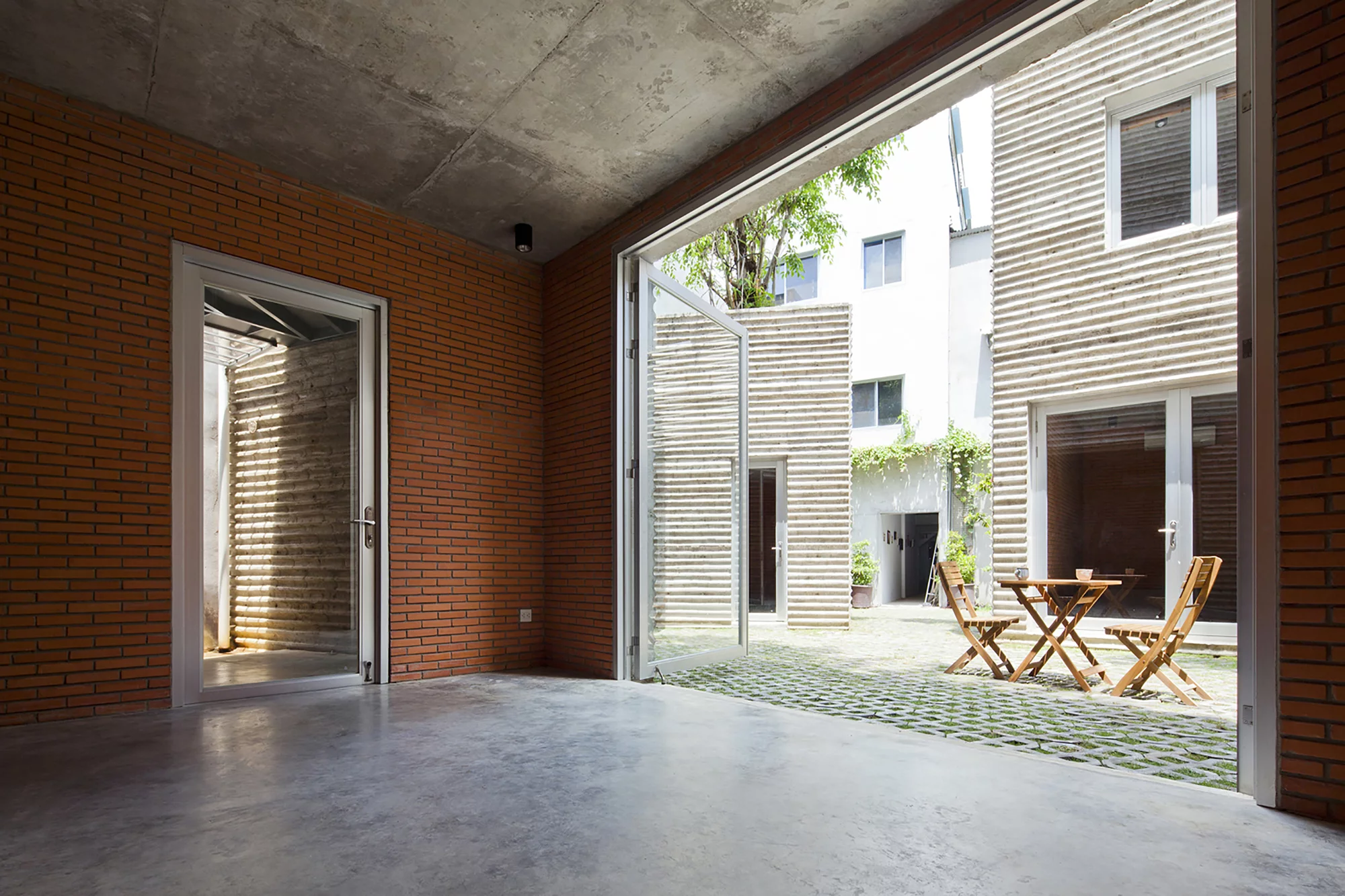 The interior of the home is split into common spaces at street level, with private rooms upstairs (Photo: Hiroyuki Oki)