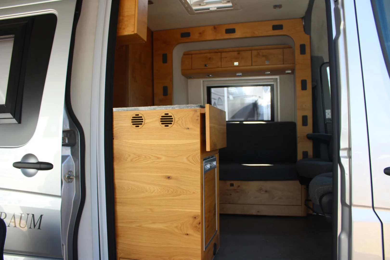 Huenerkopf has developed a Sprinter with slide-out, creating that love seat alcove you can see through the door