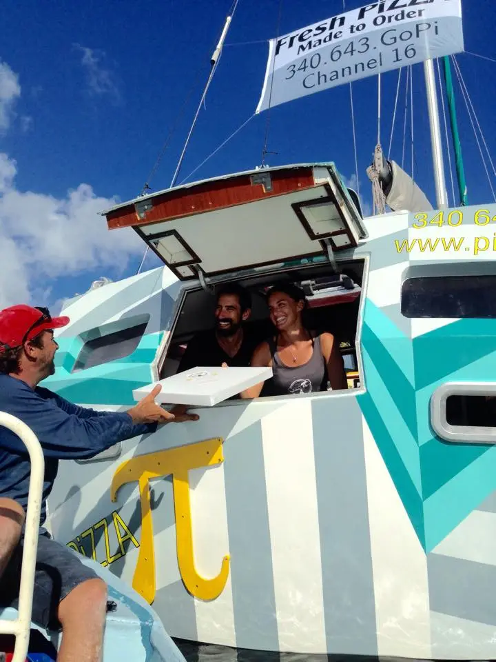 Sasha and Tara Bouis have transformed an abandoned aluminum sailboat into a floating pizza shop