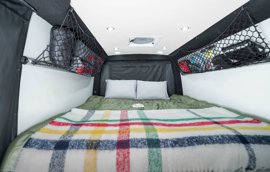 The large longitudinal bed offers a number of advantages: plenty of sleeping space, the ability to get up without rolling over the other person and no need for the sidewall flares necessary to fit a transverse bed