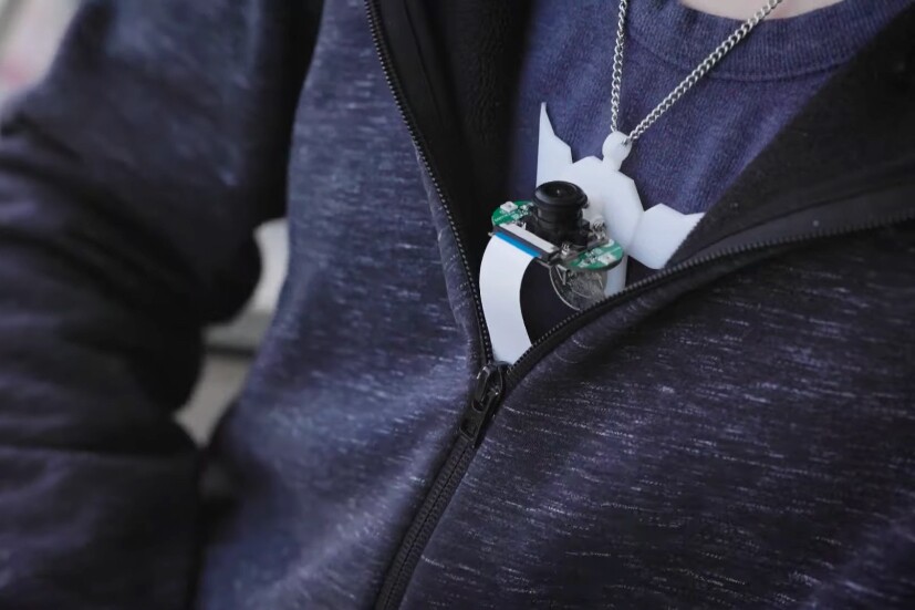 An upward-facing camera on the necklace monitors the underside of the user's chin
