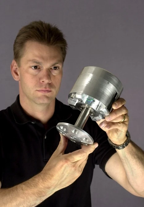 Sandia National Laboratories researcher Gary Fischer with one of the combustion-powered hopping robots