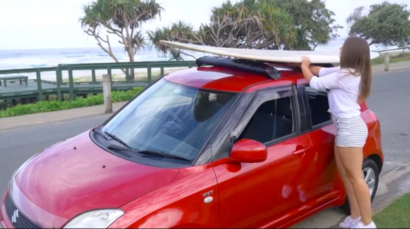 The Tair roof racks with a surfboard attached
