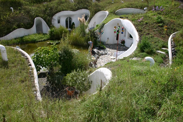 The Earth House Estate Lättenstrasse in Switzerland consists of several Hobbit Hole-style dwellings located around a wet courtyard