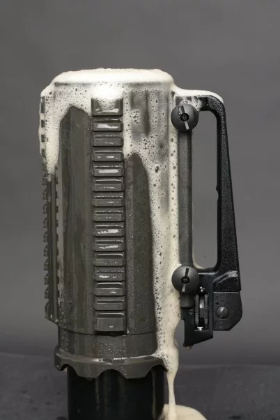 The Battle Mug is made from a solid block of aluminum, features a handle from an AR-15 rifle, and has mounting rails for accessories such as night-vision scopes