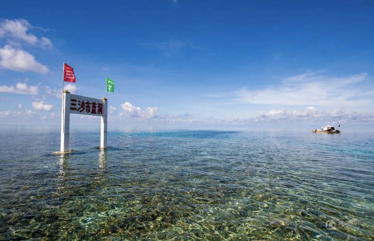The edge of the blue hole can be seen from a boat