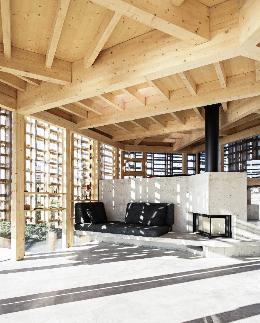 The fireplace has integrated seating and steps lead up to a raised platform