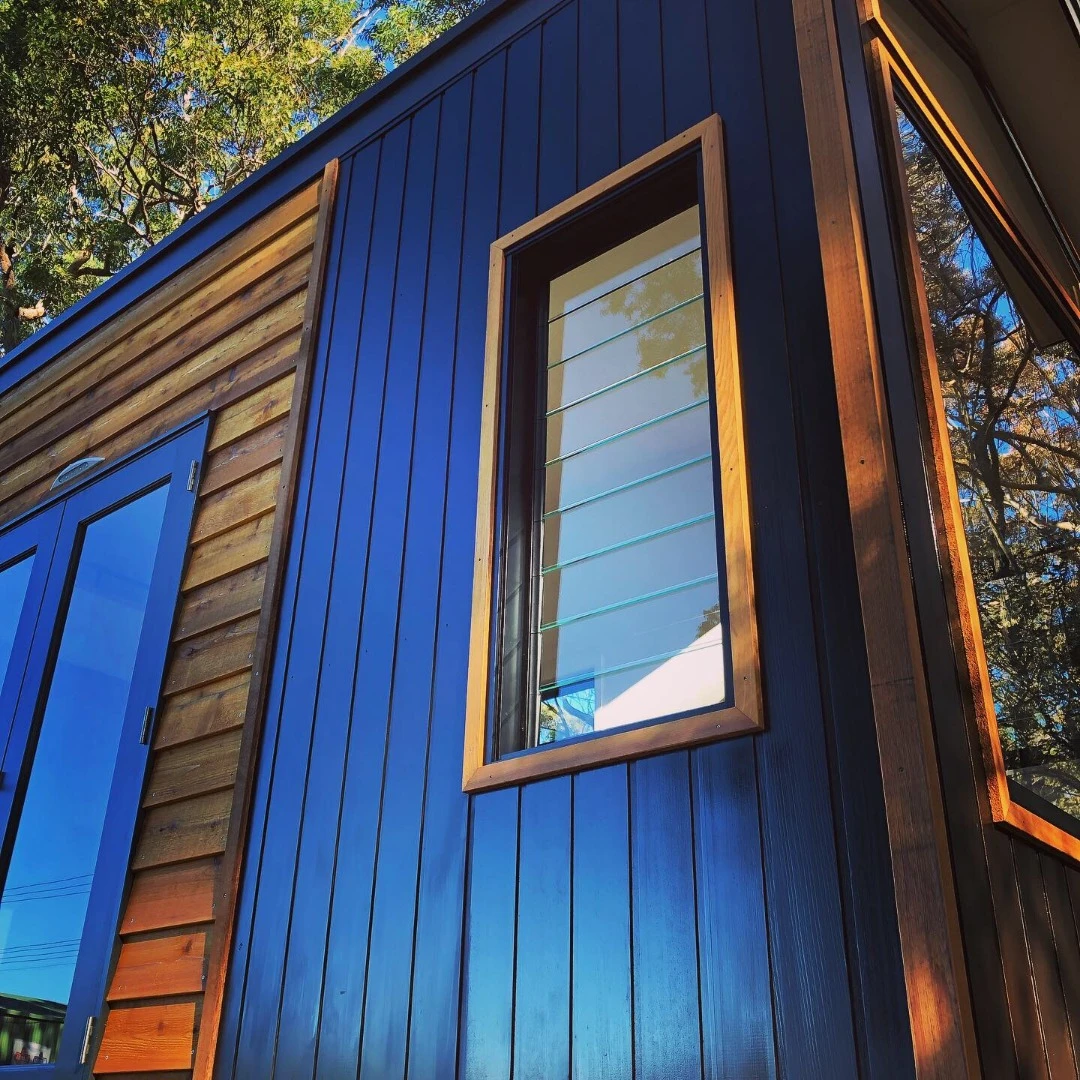 A series of cross flow ventilation windows with louvers provide natural airflow through the home