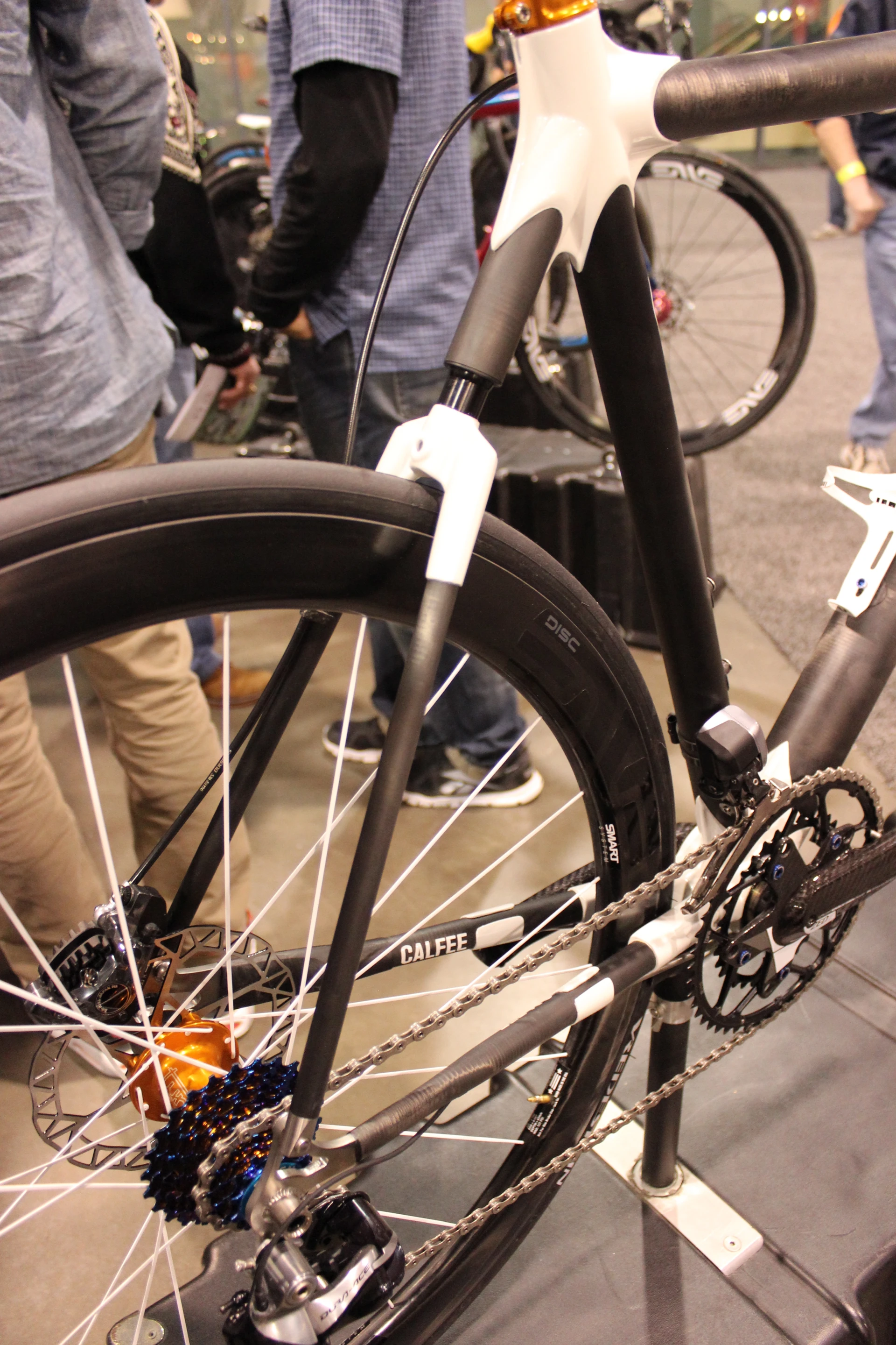 This Calfee Design road bike features a rear end where the seat stays merge into a single shaft that meets up with a steel spring housed within the frame, offering 12 mm of suspension