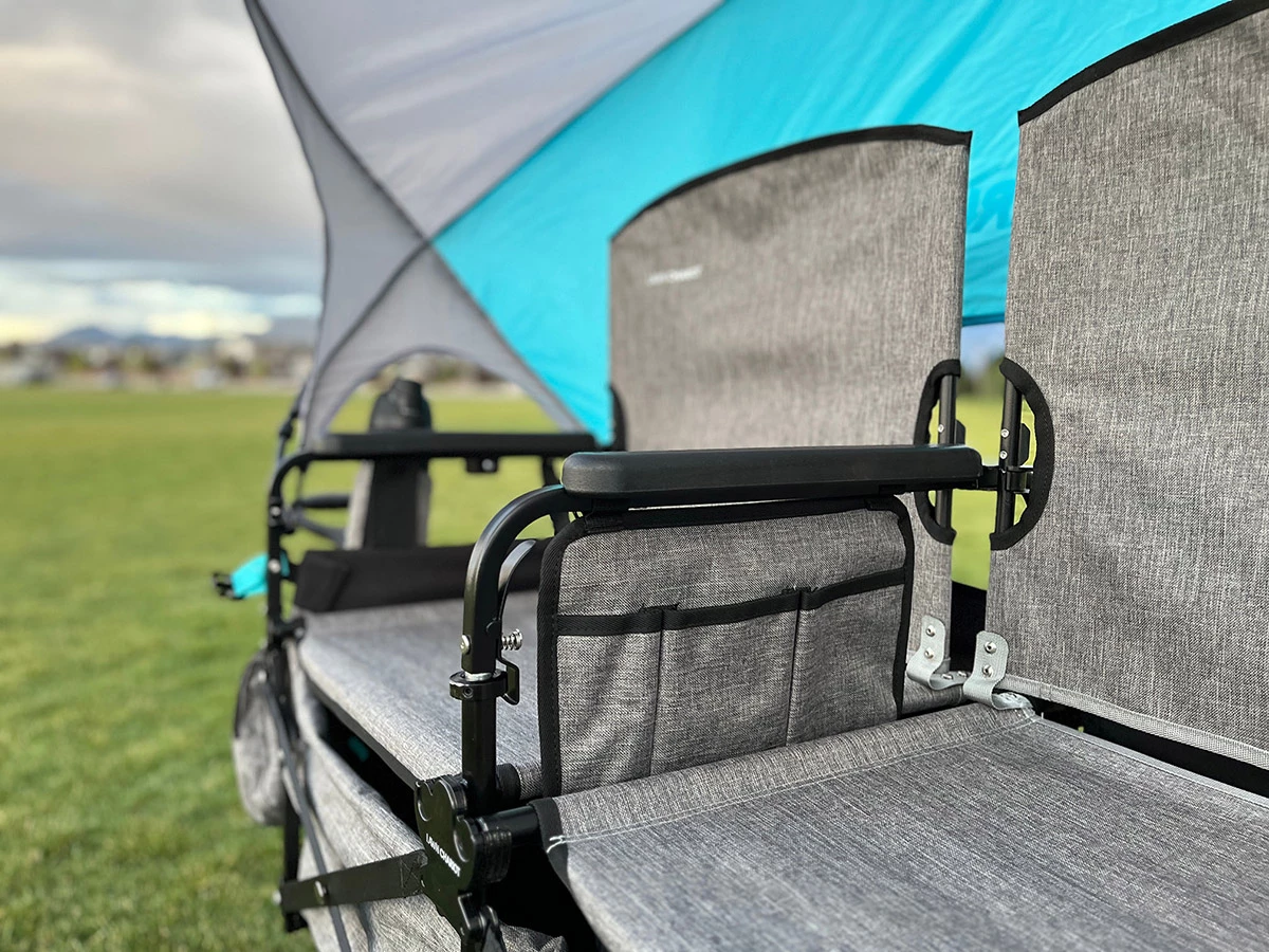 The seats are made from durable 600D polyester and get individual armrests. The foldout canopy is waterproof, and you can adjust its angle.