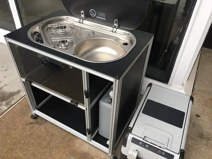VanDoIt's kitchen can be secured down and used inside the van or stood up and used outside