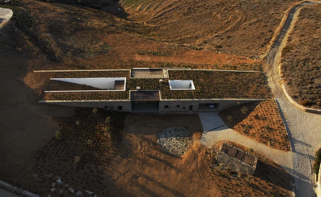 Aloni House sits in a natural gully between two sloping hills. Much of the structure nestles under the ground making it nearly impossible to grasp its true scale