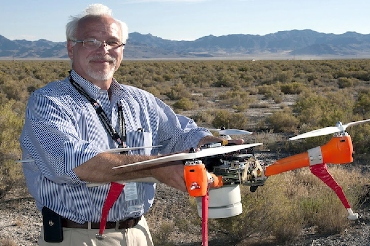 ECBC Director, Joseph Corriveau, with Deep Purple, one of two drones used to sniff out chemical and biological agents in a recent two-week test