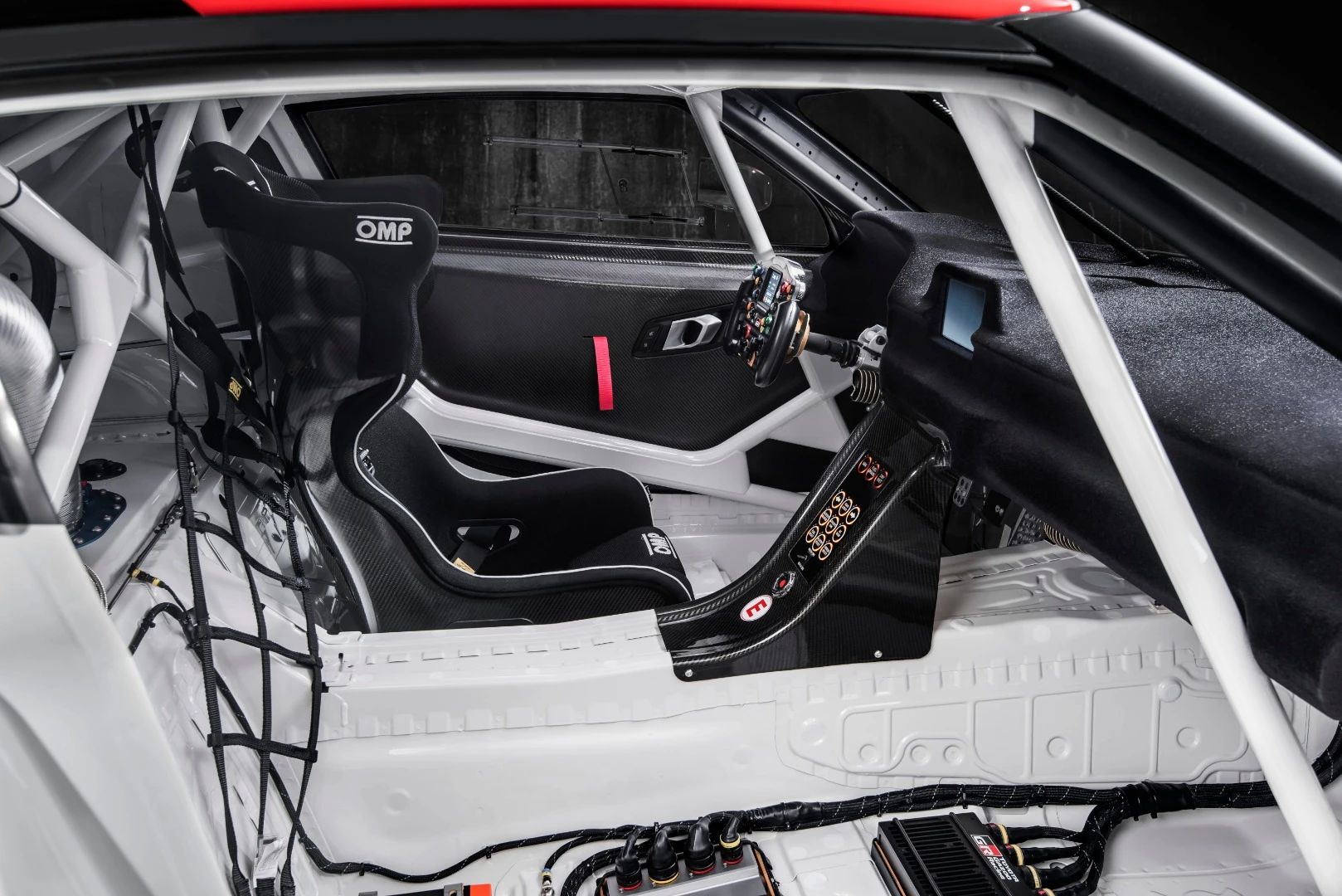 The competition-focused cabin of the Toyota GR Supra Racing Concept includes emergency shut-off and major systems cutoffs running through the passenger's side