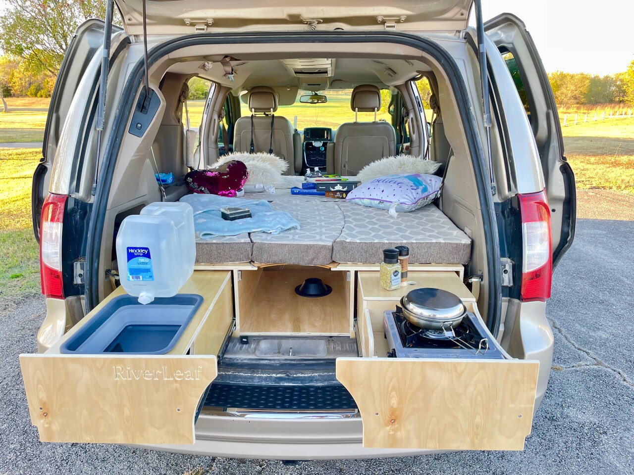The RiverLeaf Arches kits have a simple two-drawer kitchen with single-burner camping stove and collapsible sink basin, good for use with a disposable or reusable water canister with spout