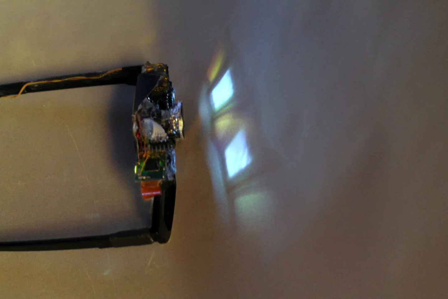 CastAR glasses projecting light onto a bent retro-reflective screen