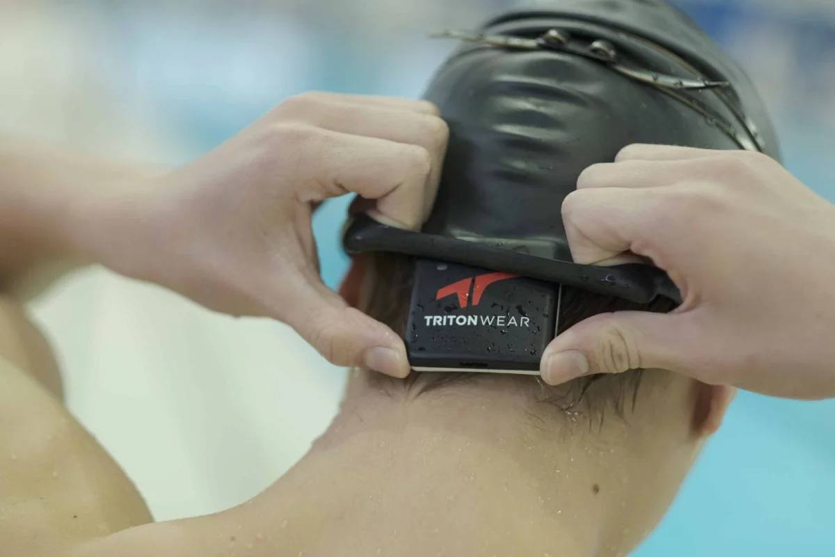 The Triton 2 is placed beneath the swimmer's cap, and transmits data to a coach's mobile device