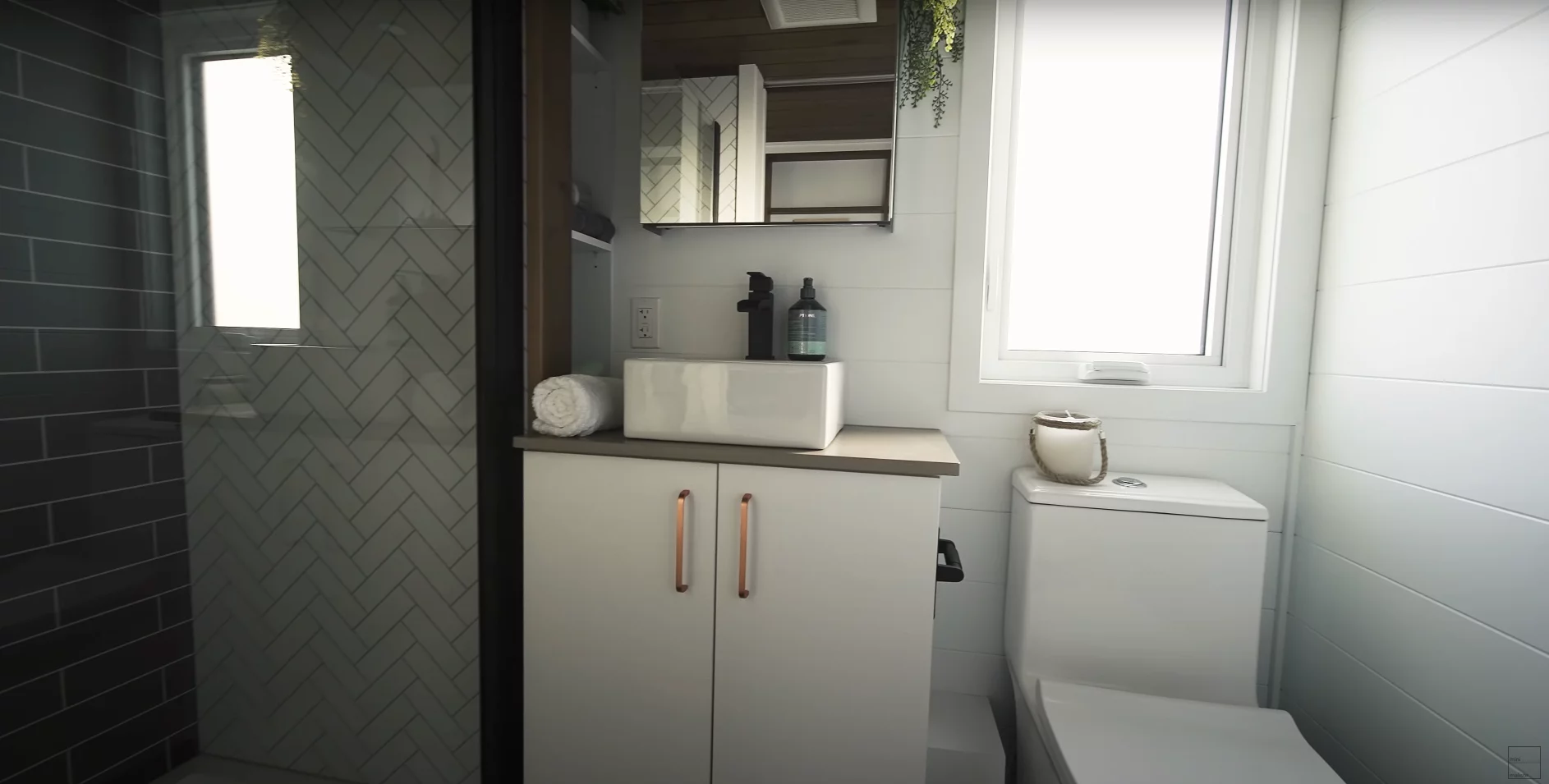 The 2024 Noyer XL's bathroom includes a shower, vanity sink and flushing toilet