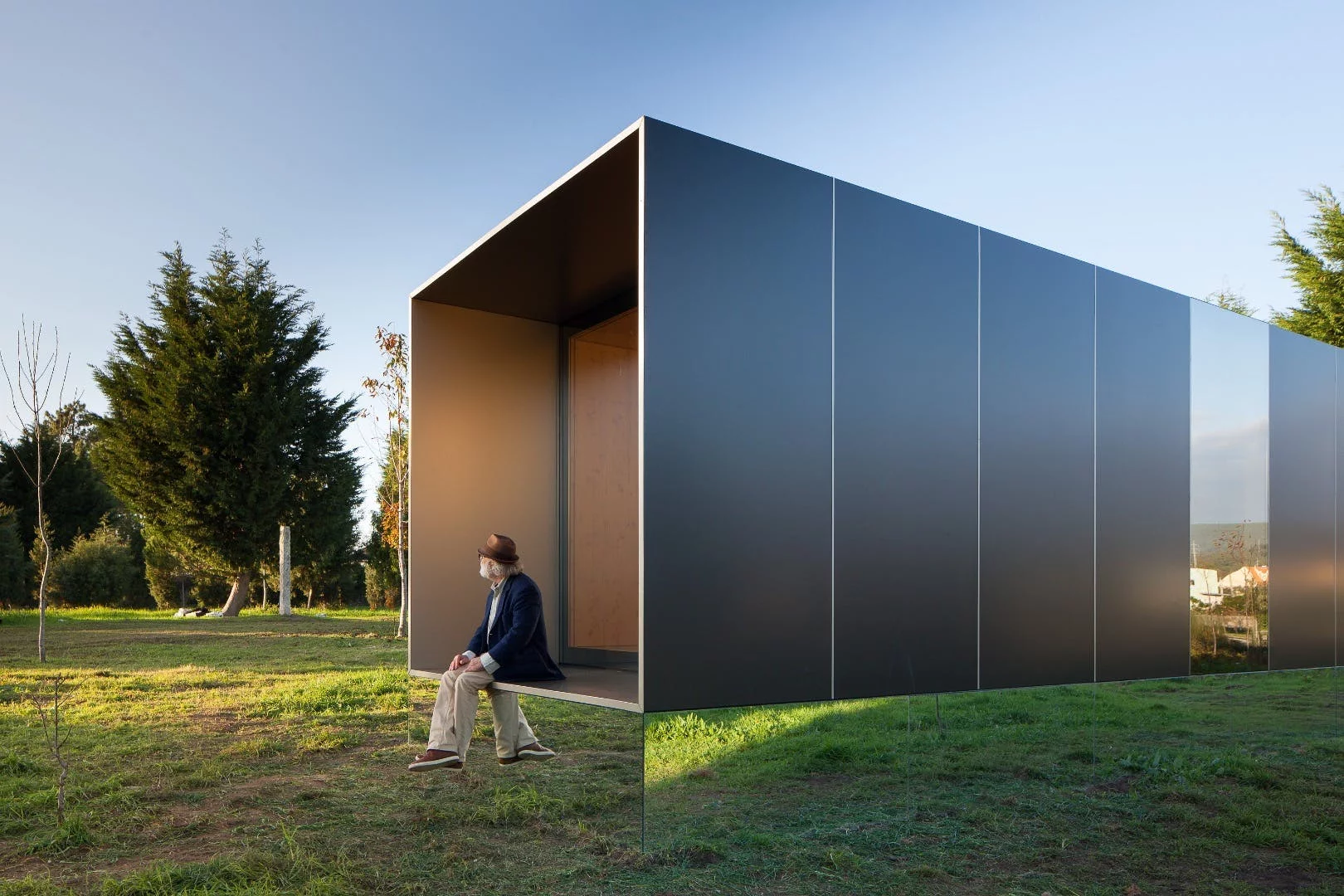 Portuguese prefabricated housing firm Mima Housing's Mima Light features a mirrored base section that makes it appear to float in mid-air