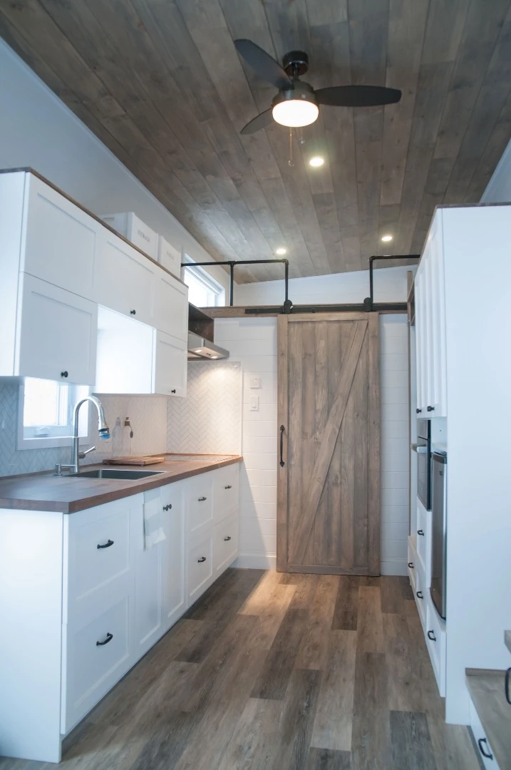 A sliding barn door provides access to the Ébène's bathroom