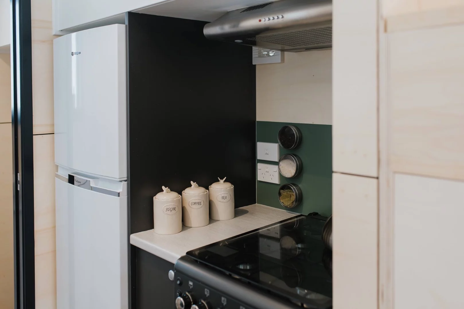 La Sombra Tiny House's kitchen includes a full-size fridge and freezer