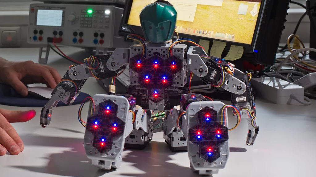 Bioloid Robot with 31 hexagonal sensor modules distributed throughout its body to give it the sense of touch (Image: Andreas Heddergott / TU Munich)