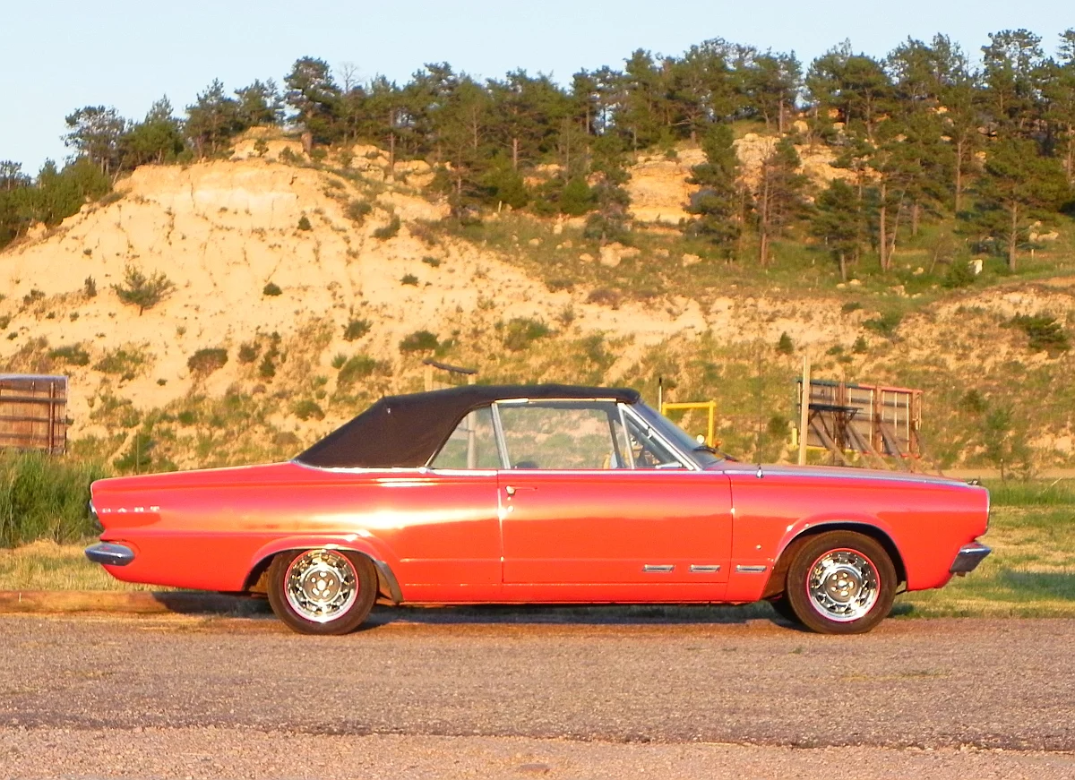 In the setting afternoon sun, the 1965 Dodge Dart GT Convertible looks great