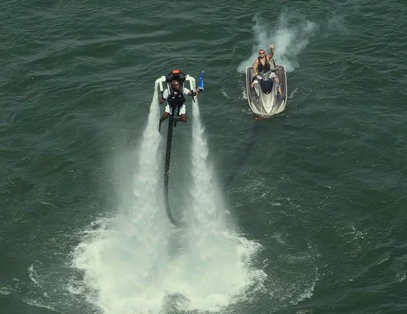 The rider stays within 40 feet of the craft below