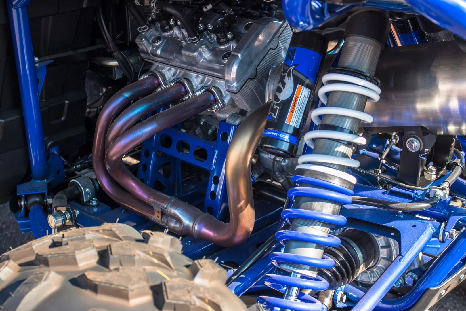 The Yamaha YXZ 1000R has a 998cc liquid-cooled DOHC inline three-cylinder engine boasting a 10,500 rpm redline