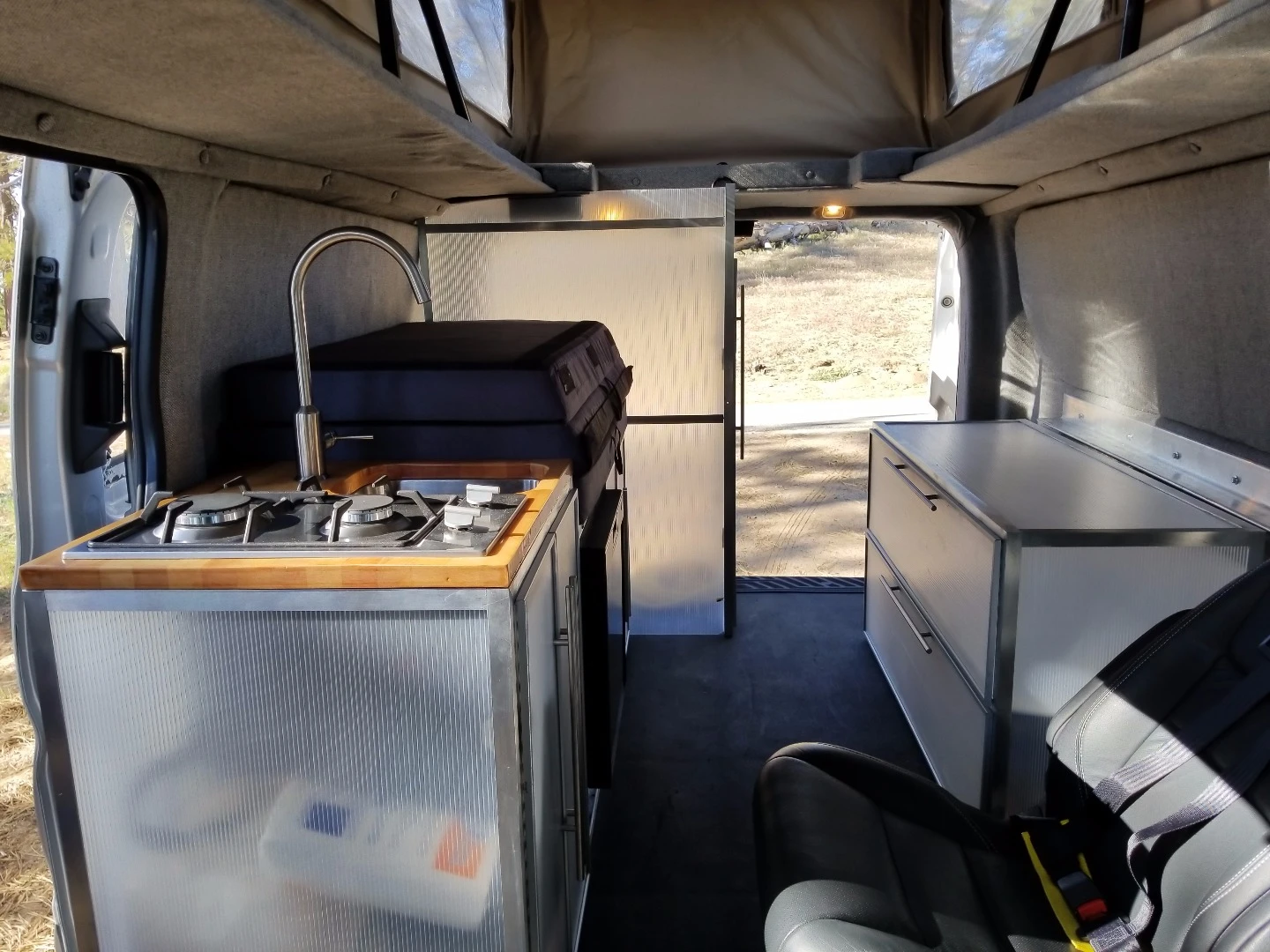 The passenger side includes the kitchen, storage cabinet and toilet room