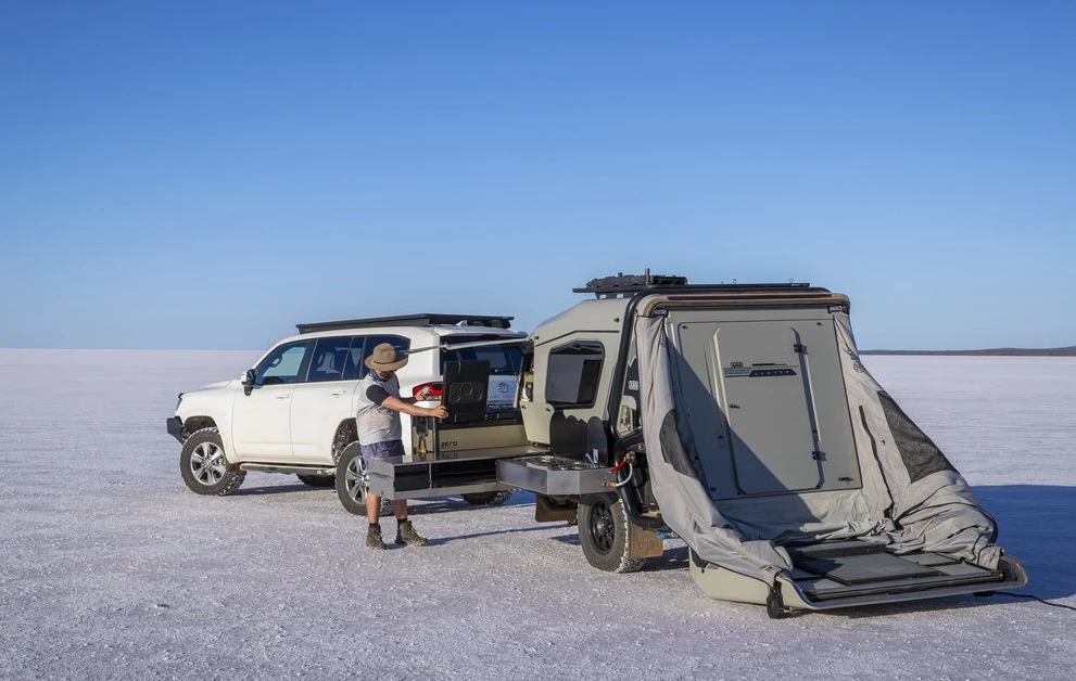 The rear hatch door lowers into a floor at the push of a button, revealing the inner wall that can be left as is or lifted into the roof of the auxiliary tent to expand the interior space