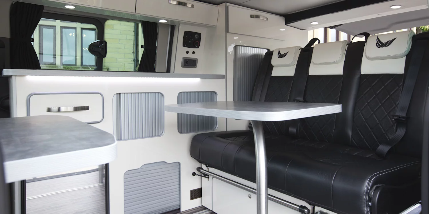 The interior offers a kitchen, dining area and beds