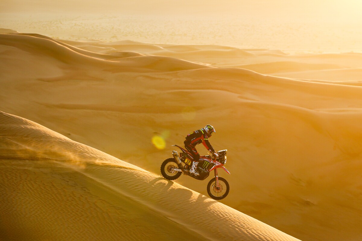 Endless, glowing sands extend into the distance behind Joan Barreda Bort on his Honda