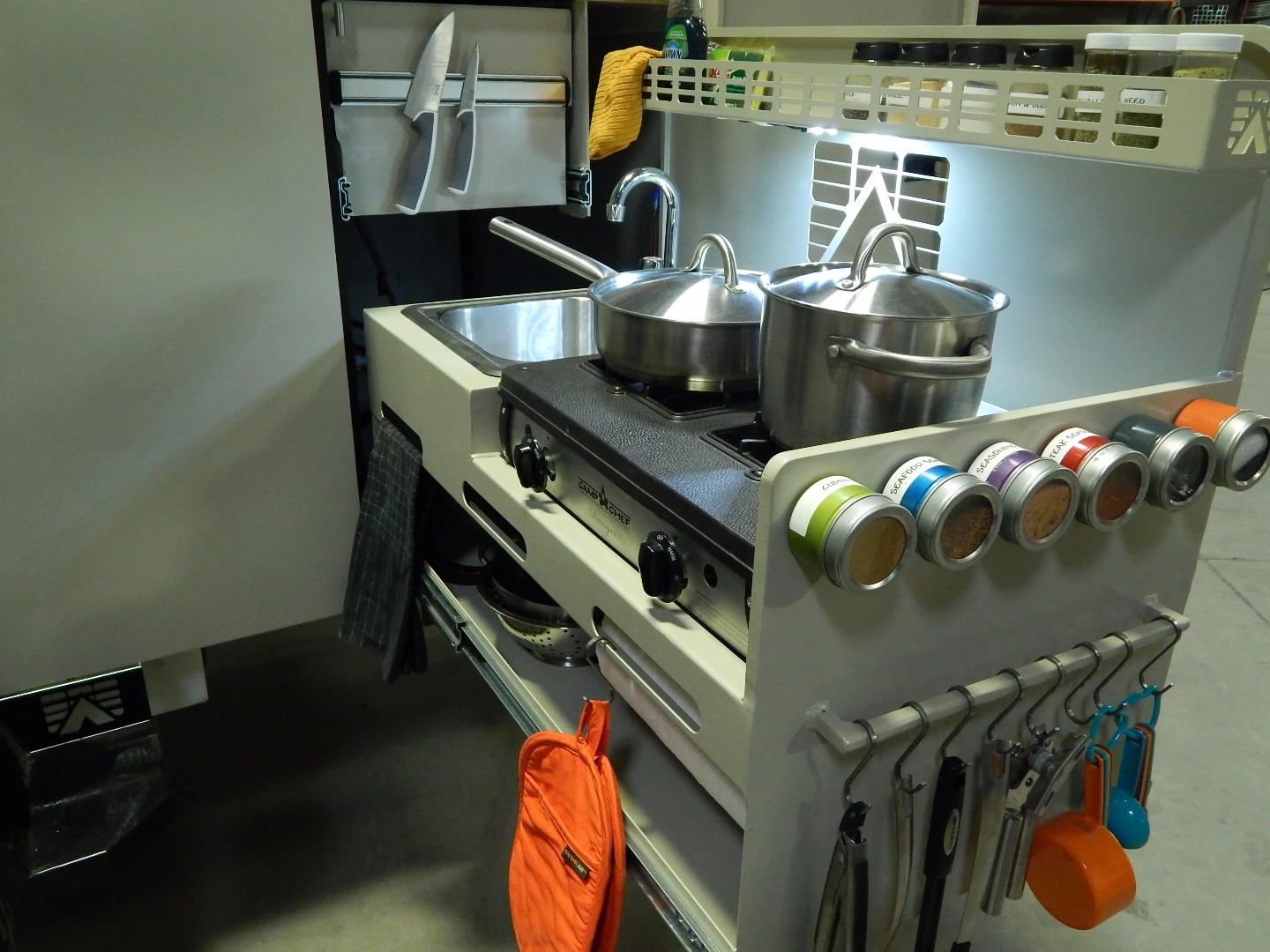 The Roll Out Kitchen includes a removable dual-burner stove, sink and plenty of smart storage space