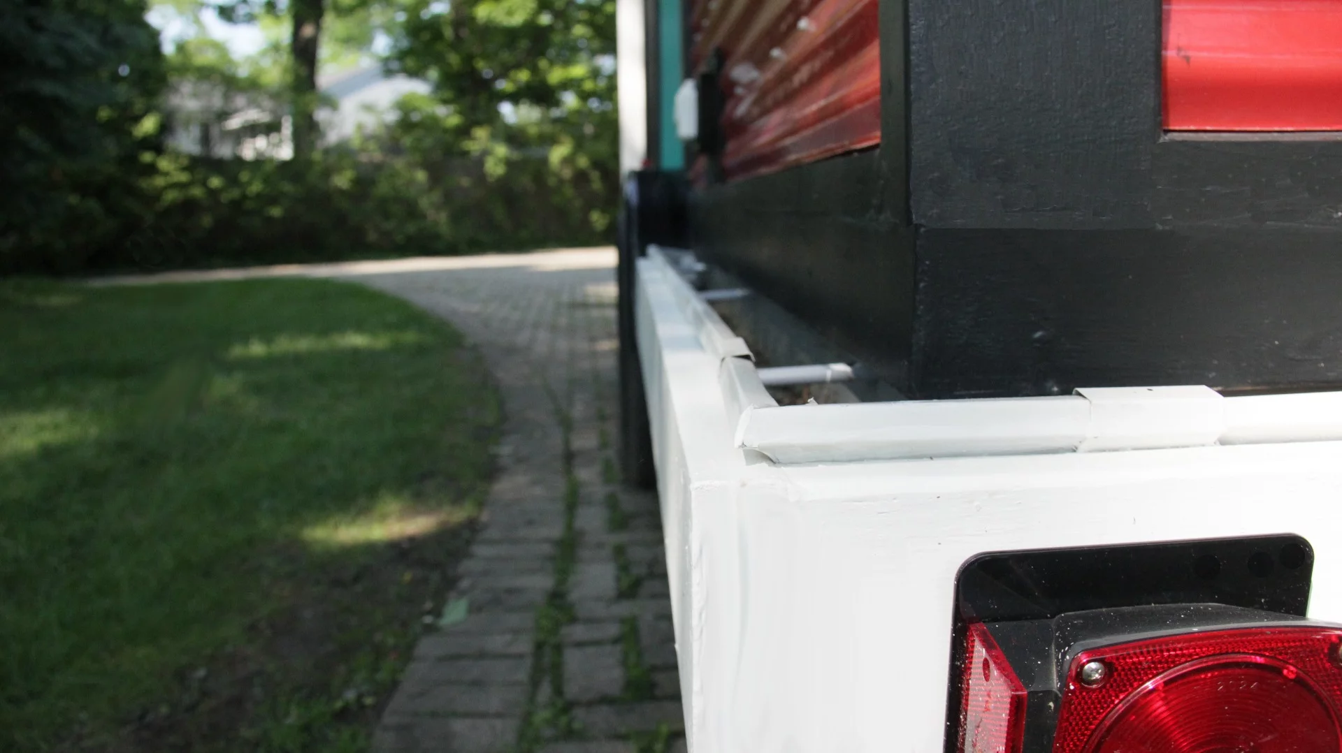 A grey water recycling system sends used water into a trough around the base of the house that contains plants