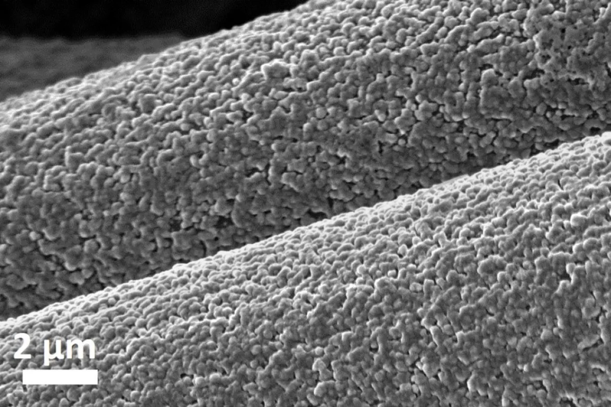 A magnified image showing aluminum depositing on carbon fibers as part of a low-cost battery electrode
