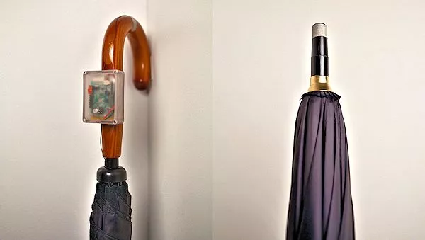 A REVEL unit attached to the handle of this umbrella makes contact with the hand of the viewer and display electrodes on the floor (Photo: Disney Research)