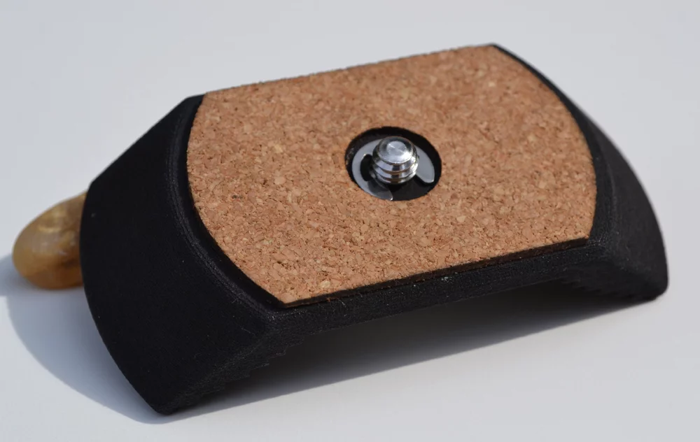 The Stow-Away is to be made from injection moulded plastic and features a thin layer of cork to cushion it on the bottom of your camera